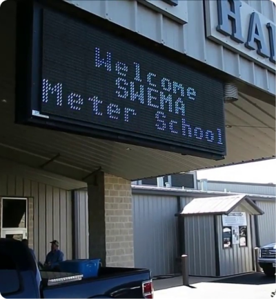 Electronic marquee reading "Welcome SHEMA Meter School"